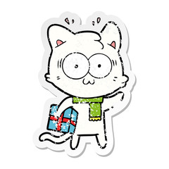 distressed sticker of a cartoon surprised cat with christmas present