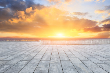 Empty square floor and modern city skyline with beautiful colorful clouds at sunset