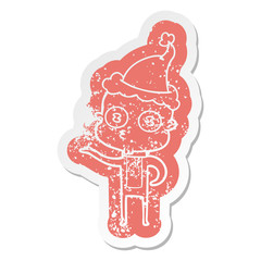 cartoon distressed sticker of a weird bald spaceman wearing santa hat