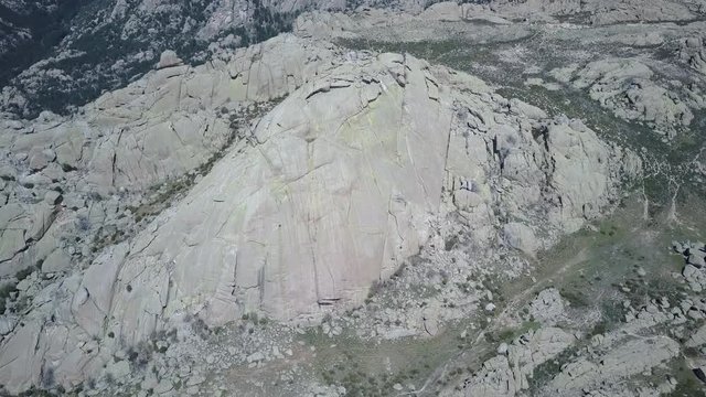 Aerial 4K Footage of "El Yelmo" rock face inside "La Pedriza" an amazing rock labyrinth at Madrid, Spain. Incredible rock formations and great place for adventure and rock climbing in wild environment