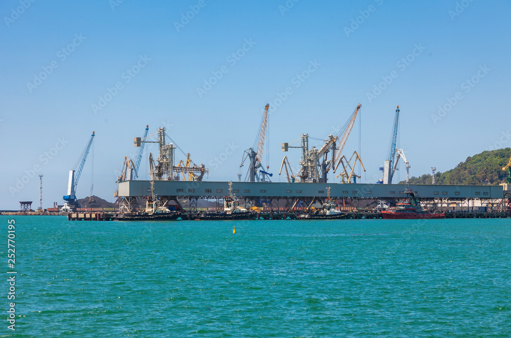 Wall mural seaport area, cranes loading ships in port, logistic import export business and transportation