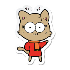 Obraz na płótnie Canvas sticker of a cartoon surprised cat wearing warm winter clothes