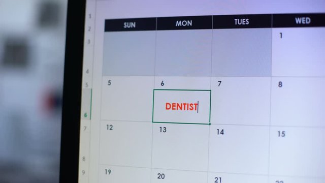 Person planning visit to dentist, making note in diary, oral care, prosthetics
