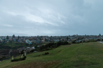 Fototapeta na wymiar Overcast sky over park and residential suburbs.
