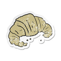 retro distressed sticker of a cartoon croissant