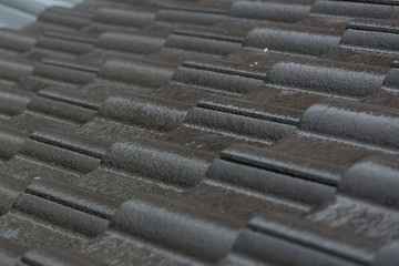 rain storm downpour on black roof tile of residential house