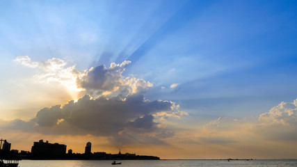 Beautiful dramatic sky clouds with light rays at sunset. Natural landscape for background