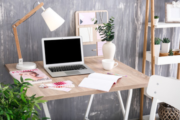 Stylish workplace with modern computer in interior of room