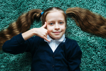 Pretty little gerl making a call me gesture.