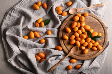 Delicious kumquat fruit on wooden board