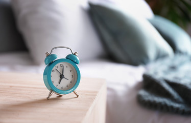 Alarm clock on table in bedroom