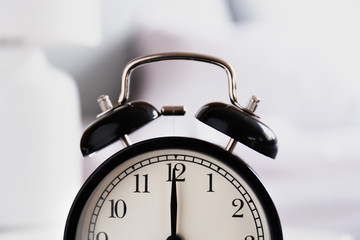 Alarm clock on blurred background, closeup