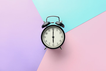 Alarm clock on color background