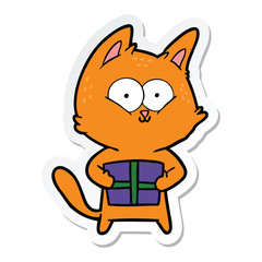 Obraz na płótnie Canvas sticker of a cartoon cat holding christmas present