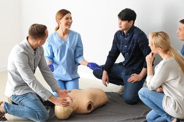 People learning to perform CPR at first aid training course