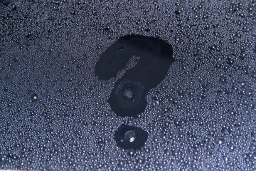 the question mark on the wet glass-Drops of water close up, texture