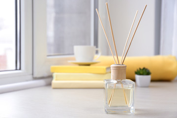 Reed diffuser on windowsill in room
