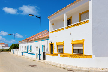 Fototapeta na wymiar Street with typical Portuguese white houses in Sagres, the municipality of Vila do Bispo, southern Algarve of Portugal.