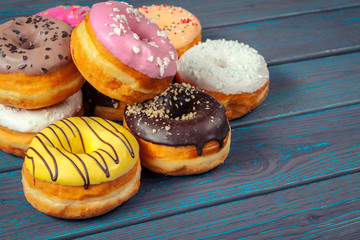 Glazed donuts on wooden background