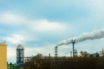 A large plan of the plant pipe, which produces harmful smoke in the environment against the background of the sky.