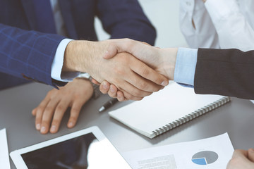 Obraz premium Business people shaking hands, finishing up a papers signing. Meeting, agreement and lawyer consulting concept