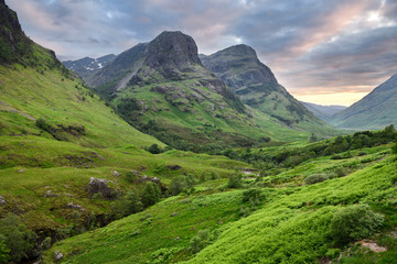 The Three Sisters peaks of Glen Coe with snow capped Bidean nam Bian and River Coe Scottish...