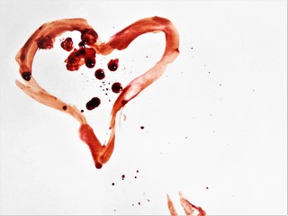 Obraz na płótnie Canvas Heart drawn in blood on a white background, the theme of love.