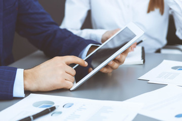 Businessman using touchpad at meeting, closeup of hands