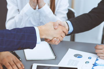 Obraz premium Business people shaking hands, finishing up a papers signing. Meeting, agreement and lawyer consulting concept