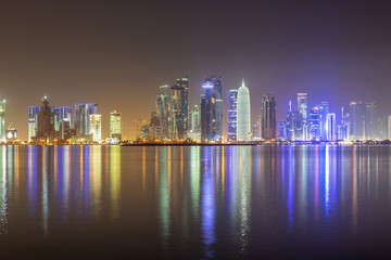 DOHA, QATAR – DECEMBER 18 2013: Reflection of westbay Doha skyline.