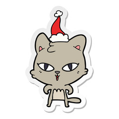 sticker cartoon of a cat wearing santa hat