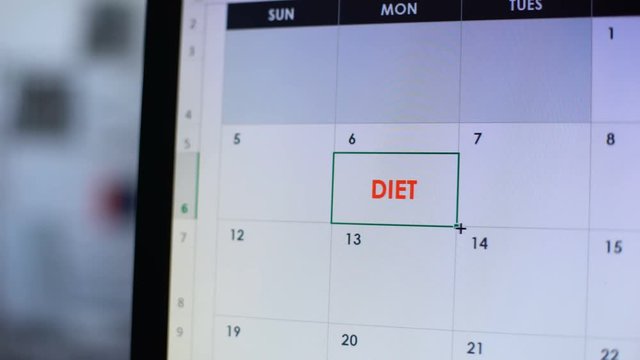Person planning go on diet, scheduling some days in online calendar on computer