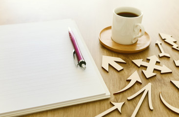 top view image of open notebook with blank pages next to cup of coffee on wooden table. ready for adding text or mockup
