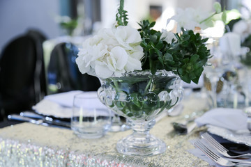 table setting decor with white flowers and crystal ware