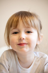 cute smiling child girl with blonde hair and quiff closeup portrait