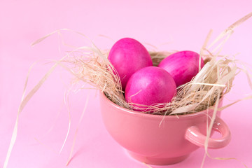  Easter eggs in pink plate on pink background