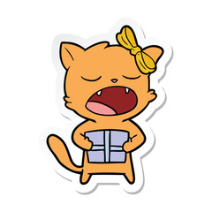 sticker of a cartoon cat with christmas present