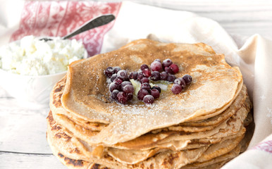many pancakes with berries