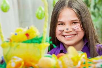 Mother and her children paint easter eggs