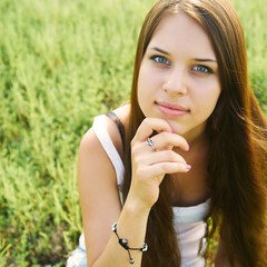 young girl on a background of grass.