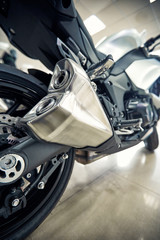 View of the back of a motorcycle with an emphasis on the chain.
