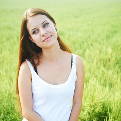 young girl on a background of grass.