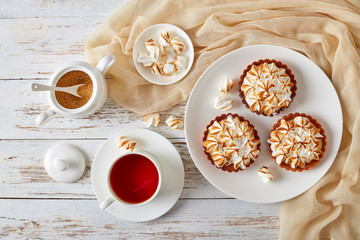Lemon meringue tartlets on a white plate