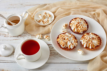 mini tarts with browned meringue peaks, close-up