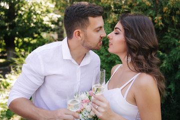 Groom and bride dring a champagne and kiss. Happy couple