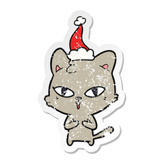 distressed sticker cartoon of a cat wearing santa hat