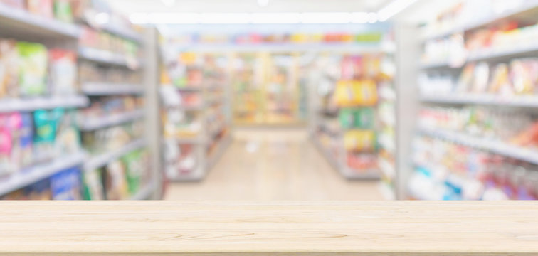Empty Wood table top with supermarket grocery store blurred defocused background with bokeh light for montage product display