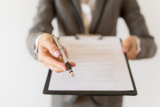 Woman holding ready to sign contract and pen