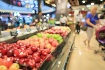 Abstract blur fresh organic fruits on shelf in grocery store defocused background