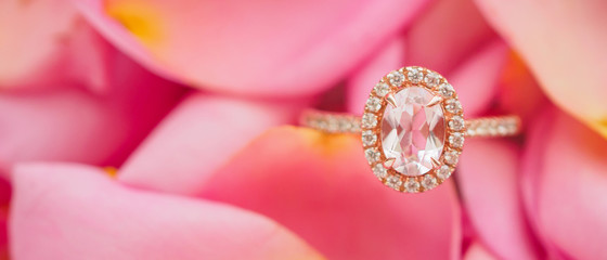Jewelry pink diamond ring on beautiful rose petal background close up